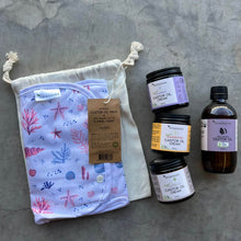 Load image into Gallery viewer, Set of skincare products including jars and a bottle on a textured surface